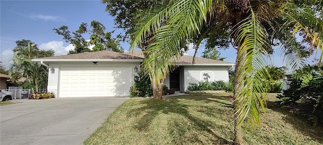 ranch-style house featuring a front lawn and a garage