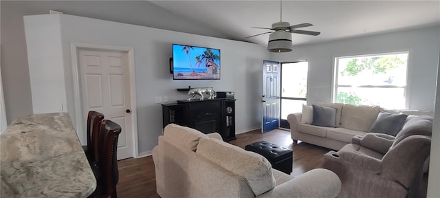 living room featuring dark hardwood / wood-style flooring, ceiling fan, and lofted ceiling