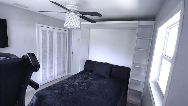 bedroom with ceiling fan and multiple windows