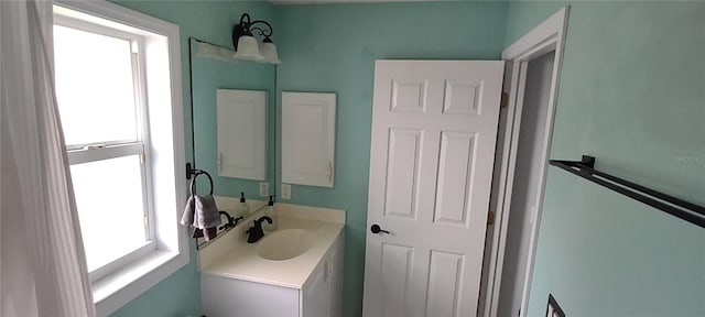 bathroom featuring a healthy amount of sunlight and vanity