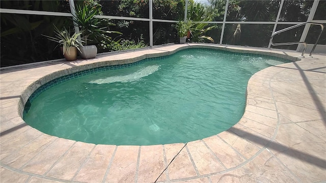 view of pool with a patio and a lanai