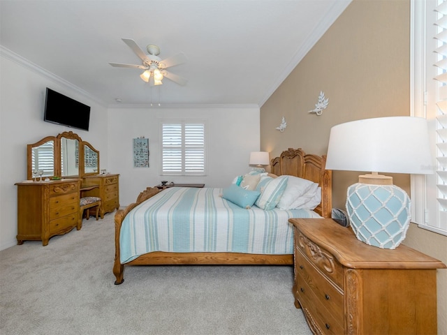 bedroom featuring ceiling fan, light colored carpet, and ornamental molding