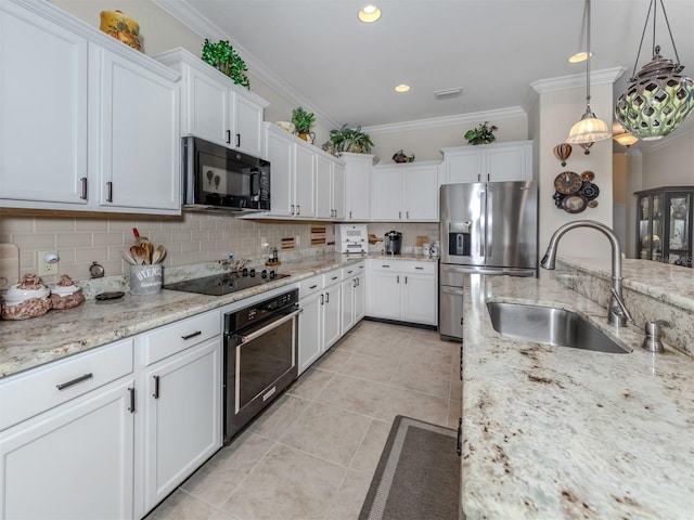 kitchen with crown molding, sink, black appliances, decorative light fixtures, and white cabinetry