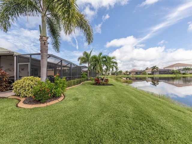 view of yard featuring glass enclosure and a water view