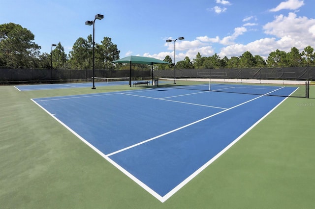 view of tennis court featuring basketball court