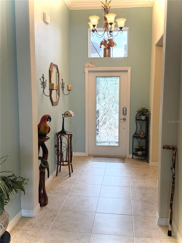 foyer entrance featuring a chandelier, light tile patterned floors, and ornamental molding