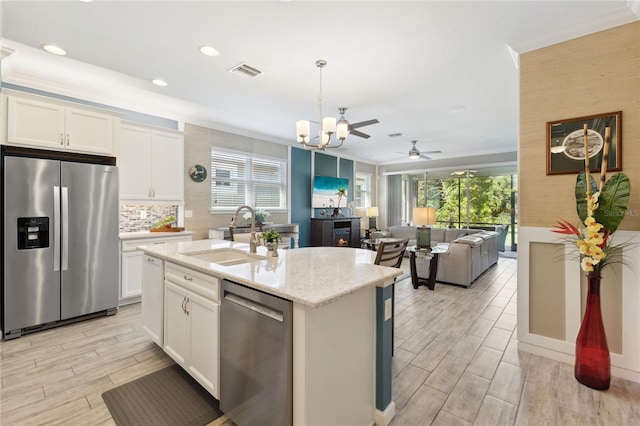 kitchen featuring a wealth of natural light, ceiling fan, appliances with stainless steel finishes, and sink