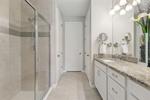 bathroom with tile patterned flooring, an enclosed shower, and vanity