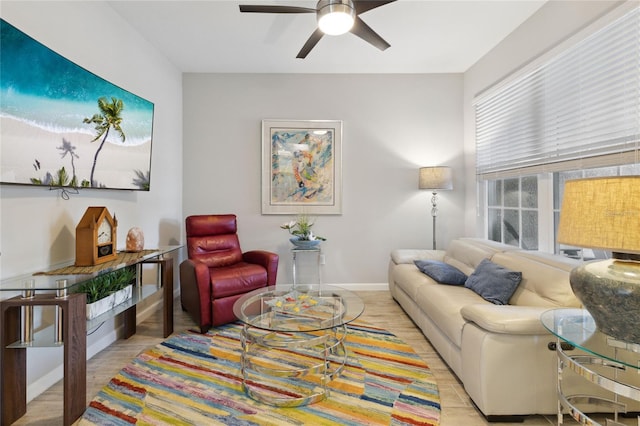 living room with light wood-type flooring and ceiling fan