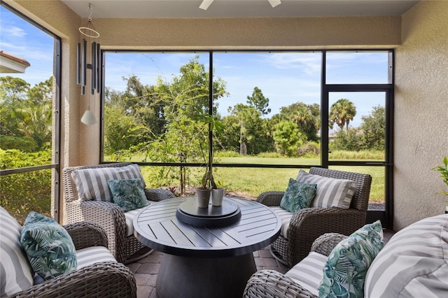 sunroom featuring ceiling fan