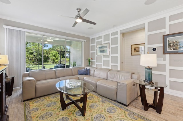 living room with light wood-style flooring, ceiling fan, and crown molding