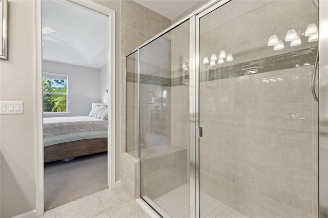 full bathroom with ensuite bathroom, baseboards, a shower stall, and tile patterned floors