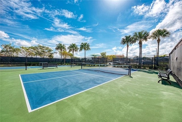 view of sport court featuring fence