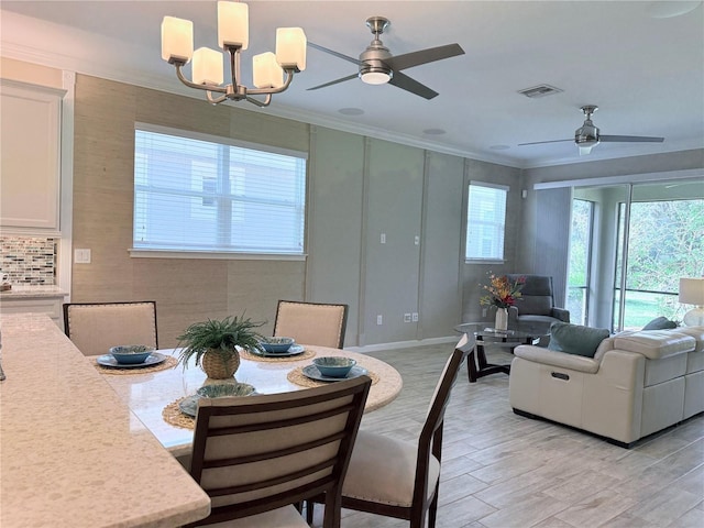 12000 Tapestry Ln, Venice, FL 34293 - dining area featuring visible vents, ornamental molding, and ceiling fan with notable chandelier