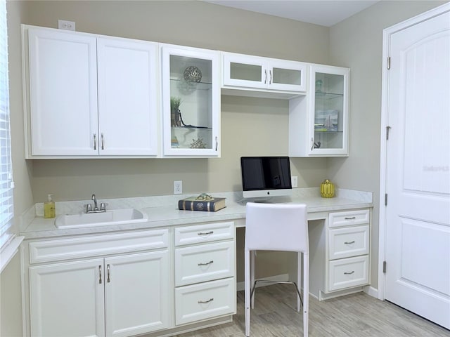 12000 Tapestry Ln, Venice, FL 34293 - office area with light wood-style floors, built in desk, and a sink
