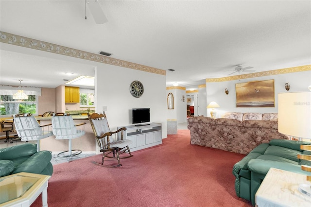 living room with ceiling fan and carpet floors