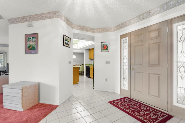 entrance foyer featuring light tile patterned floors and a textured ceiling