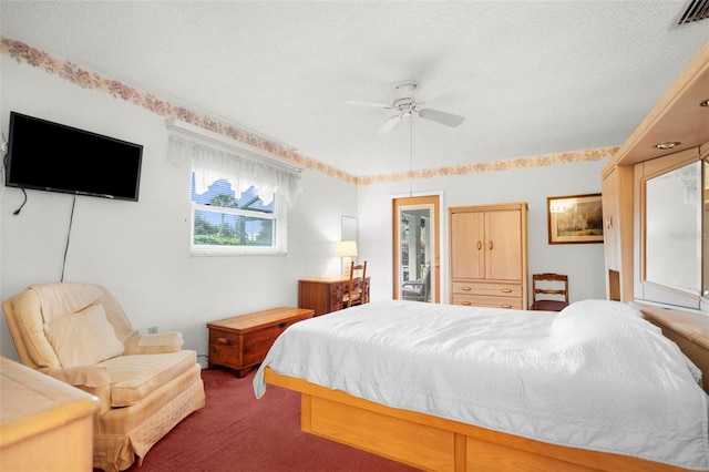 bedroom featuring ceiling fan, carpet floors, and a textured ceiling