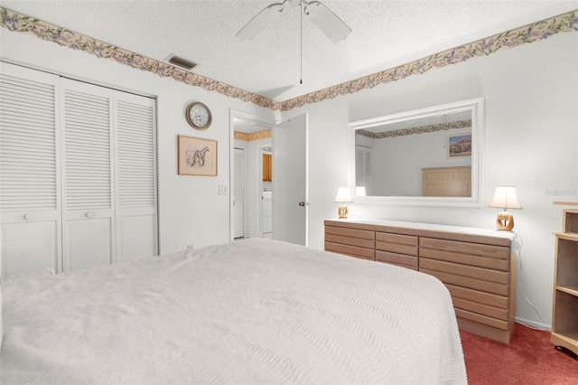 bedroom with ceiling fan, carpet floors, a closet, and a textured ceiling