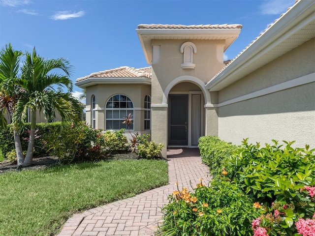 doorway to property featuring a yard