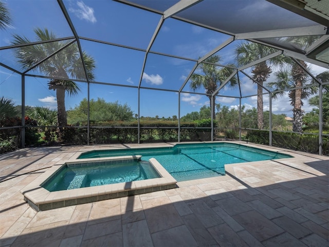 view of pool with a patio, an in ground hot tub, and a lanai