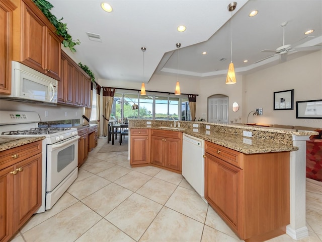 kitchen with sink, hanging light fixtures, white appliances, light tile patterned floors, and ceiling fan