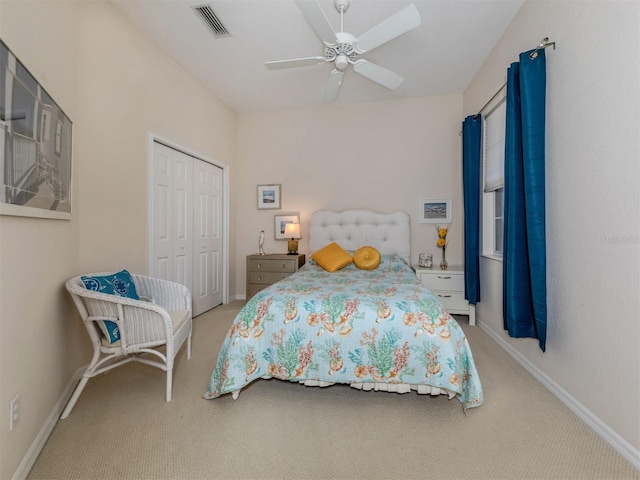 carpeted bedroom featuring a closet and ceiling fan