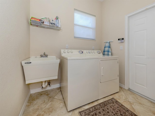 laundry room featuring light tile patterned floors, sink, and independent washer and dryer