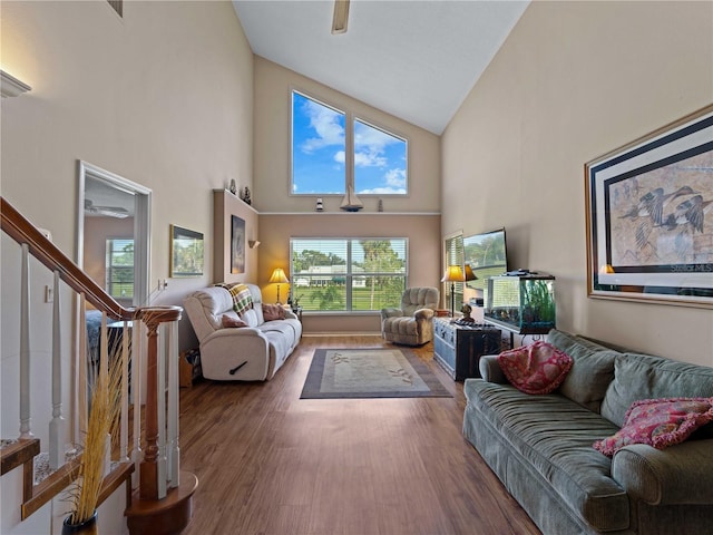 living room featuring wood-type flooring, high vaulted ceiling, and ceiling fan