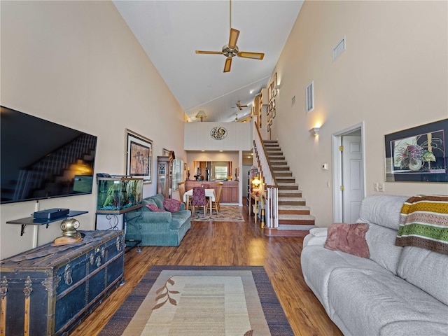 living room featuring high vaulted ceiling, ceiling fan, and hardwood / wood-style floors