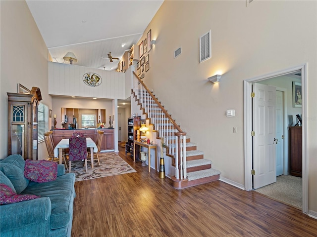 living room featuring hardwood / wood-style floors and a high ceiling