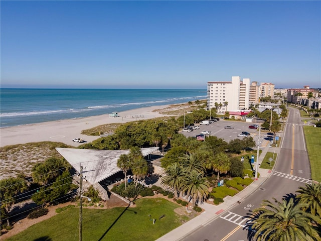 aerial view with a water view and a beach view