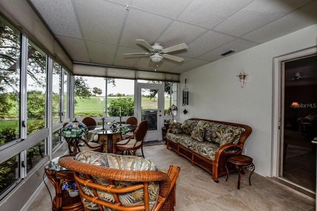 sunroom with a paneled ceiling and a wealth of natural light