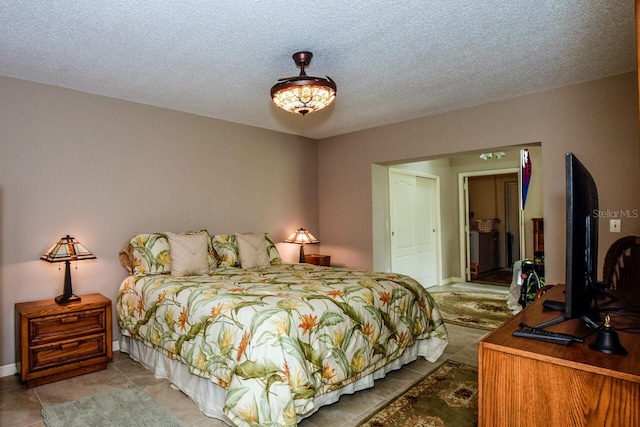 tiled bedroom with a textured ceiling