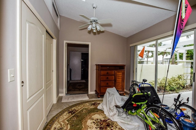 tiled bedroom with access to exterior, ceiling fan, a textured ceiling, lofted ceiling, and a closet