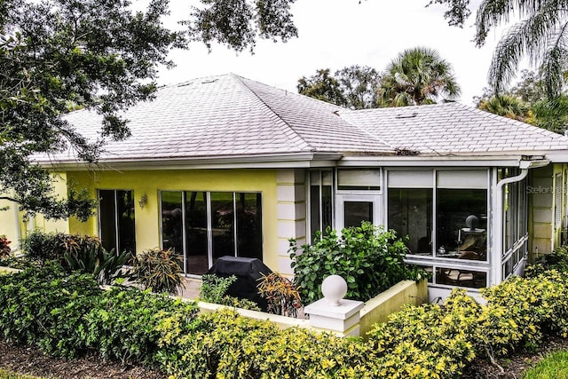 rear view of property with a sunroom