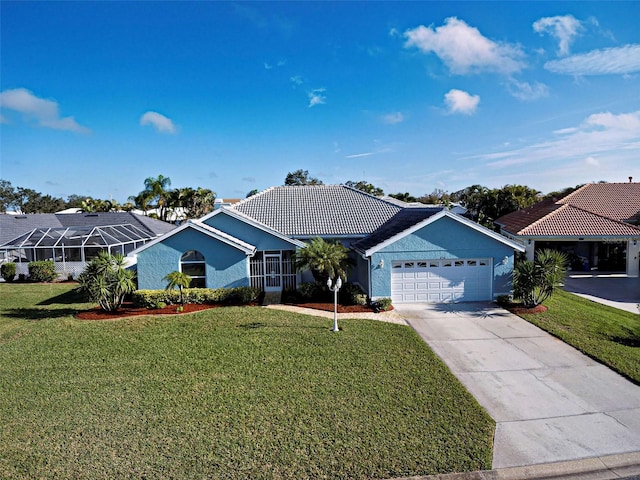 ranch-style house featuring a garage and a front lawn