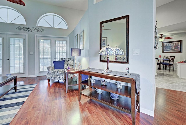 interior space featuring high vaulted ceiling, ceiling fan, hardwood / wood-style flooring, and french doors