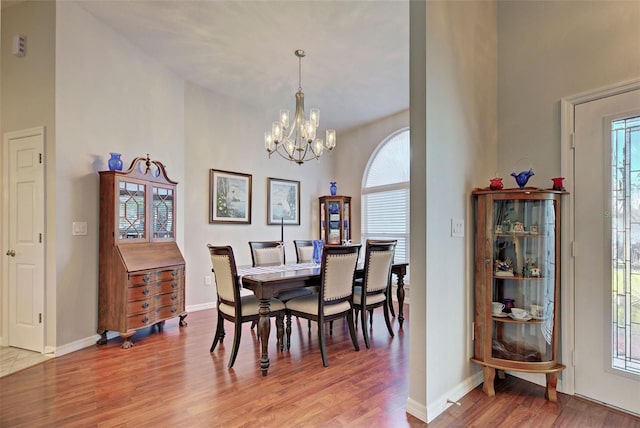 dining room with wood-type flooring, a chandelier, and a healthy amount of sunlight