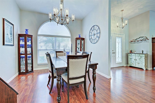 dining area with wood-type flooring and a chandelier