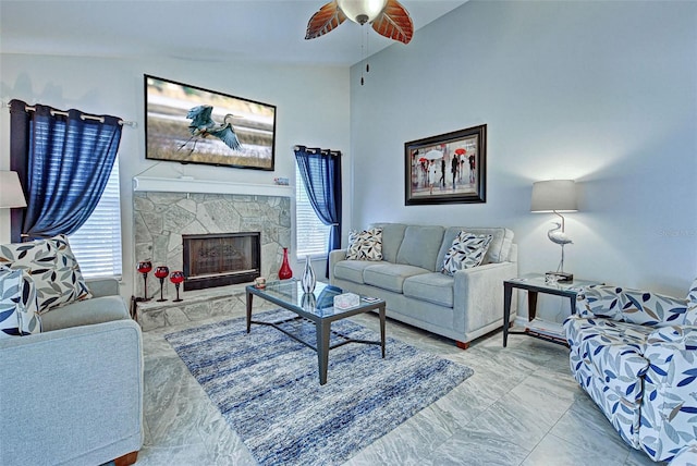 living room with lofted ceiling, a fireplace, ceiling fan, and plenty of natural light