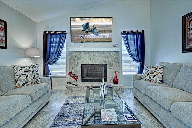 living room featuring a stone fireplace and lofted ceiling