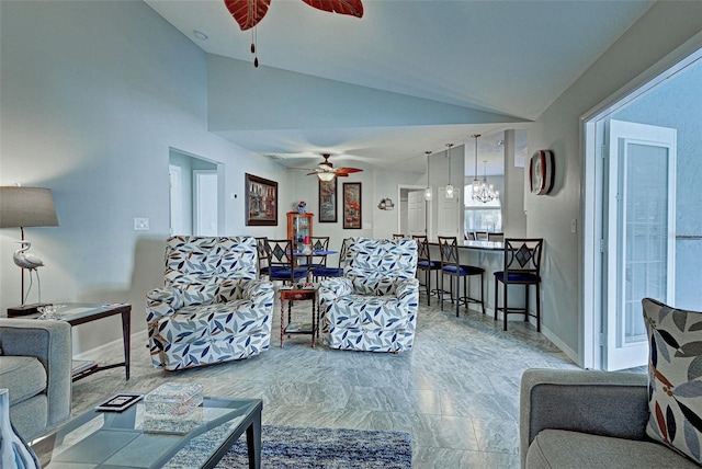 living room featuring ceiling fan with notable chandelier and lofted ceiling