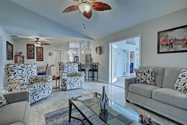 living room with ceiling fan with notable chandelier, plenty of natural light, and high vaulted ceiling