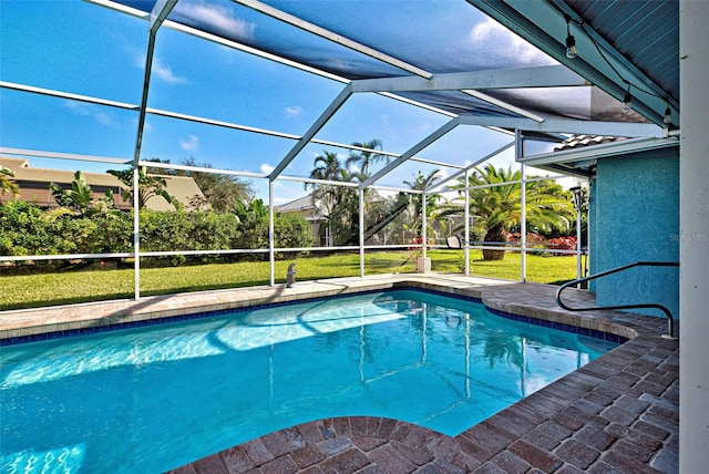 view of pool with glass enclosure and a yard