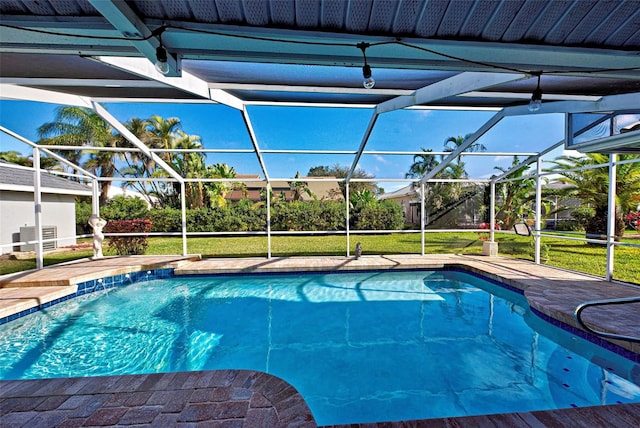 view of swimming pool with glass enclosure and a lawn