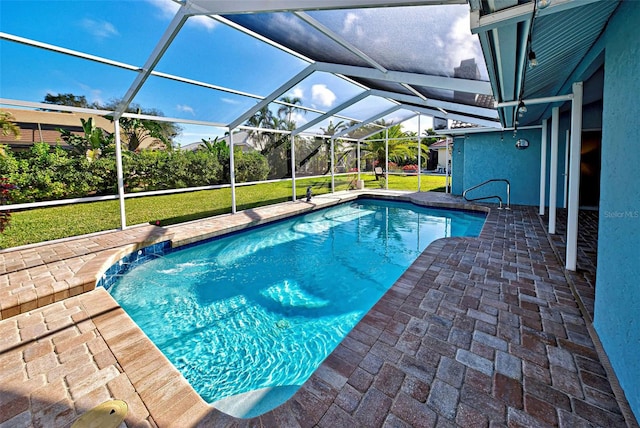 view of swimming pool featuring a patio, a yard, a lanai, and pool water feature