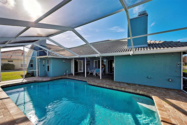 view of swimming pool with a patio and a lanai