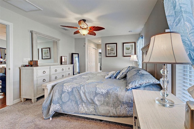 carpeted bedroom with ceiling fan and a closet