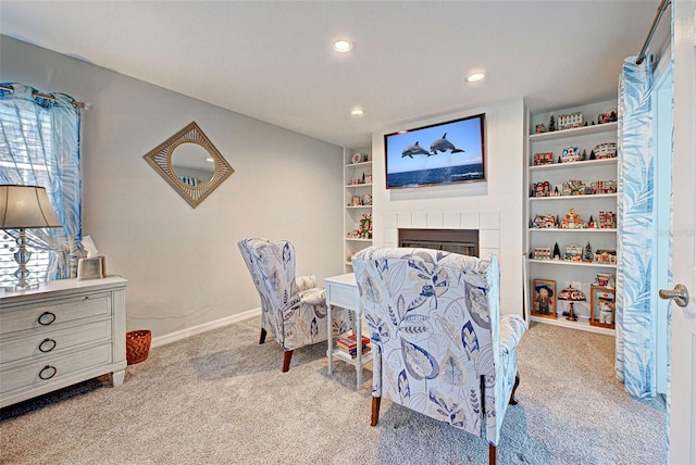 interior space with a tile fireplace and light carpet